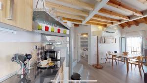 a kitchen with a table and a dining room at El 1 de Amador de los Rios in Toledo +14 photos