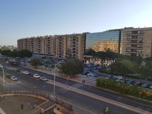 a city street with cars parked in front of a building at Cinecittà Luxury GUEST HOUSE in Rome