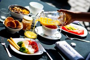 a person pouring a drink into a bowl of food at Continental Hotel in Reims