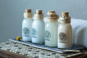 a group of four bottles of milk on a table at De Kombuys in Oudtshoorn +122 photos