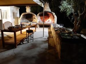 a table and chairs in front of a stone fireplace at Mafrolla Carlo in Vieste