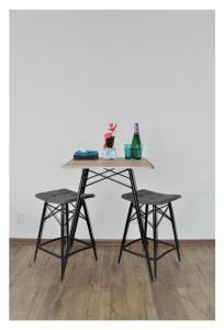 a table with two chairs and a table with a table at SGL apartments Lavickova in Trenčín