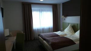 a hotel room with a bed and a window at Rhönblick Landhotel - Restaurant - Countrypub in Petersberg +49 photos
