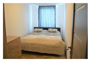 a small bedroom with a bed and a window at SGL apartments Lavickova in Trenčín