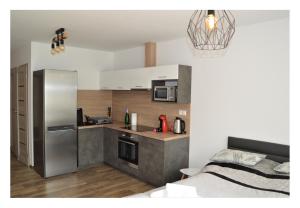 a kitchen with a stainless steel refrigerator and a counter at SGL apartments Lavickova in Trenčín