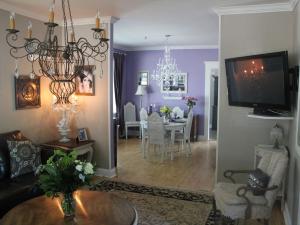 a living room with purple walls and a dining room at Charles Street Vacation Home in Lethbridge