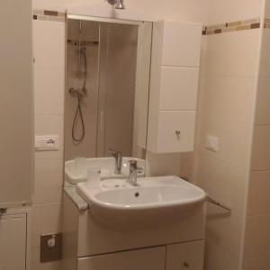 a white bathroom with a sink and a shower at Da Nicola e Laura in Santo Stefano di Cadore +19 photos
