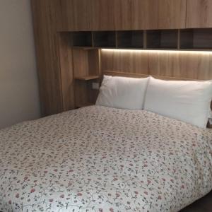 a bedroom with a bed with a floral comforter at Da Nicola e Laura in Santo Stefano di Cadore