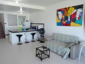 a living room with a couch and a table in it at Imóvel na Beira-Mar in Pipa