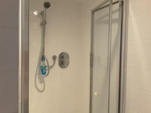 a shower with a shower head in a bathroom at Fabulous Double ensuite room in Sefton Park Lark Lane in Liverpool