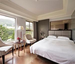 Letto o letti in una camera di JBG Hotspring Resort Hotel