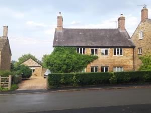 an old brick house on the side of a street at Wayside House B&B in Whichford +14 photos