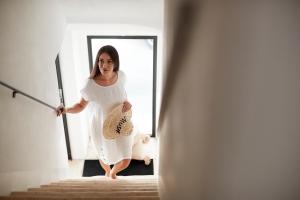 a woman walking down the stairs with a sword at Musae Relais & SPA in Polignano a Mare