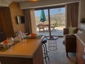 a kitchen and living room with a table with wine glasses at The Loft Gozo in Xagħra