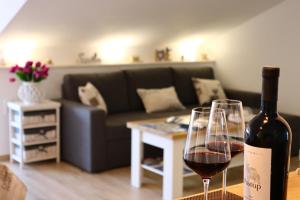 a bottle of wine sitting next to a wine glass at Apartment Marina in Korčula