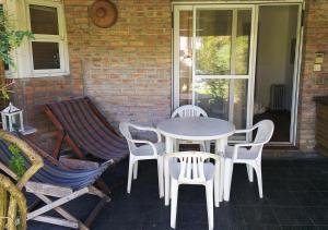 a white table and chairs on a patio at La Casa de Kelly in Federación