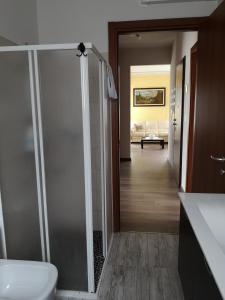 a bathroom with a toilet and a hallway at La Casa Dei Nonni in Bussoleno
