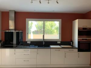 a kitchen with a sink and a window at La Maison de Caillette in Camaret-sur-Aigues +4 photos