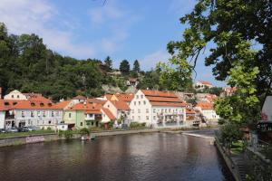 a town with a river and buildings on a hill at Hotel CK Park in Český Krumlov