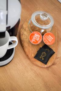 a wooden table with three stickers on a table with a cup at VOYA Apartments - a luxury oasis in the old town in Braşov
