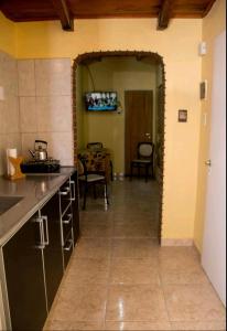 a kitchen with a counter and a hallway with a table at Casa Mandala in Trelew