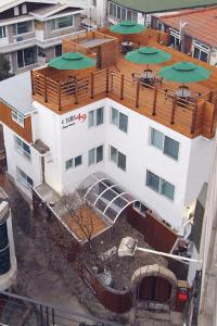 a white building with green umbrellas on top of it at Crib 49 Guesthouse - Foreigner only in Seoul