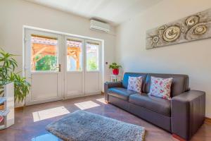 a living room with a couch and a door at Villa M in Crikvenica