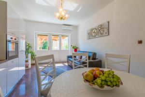 a kitchen with a table with a bowl of fruit on it at Villa M in Crikvenica