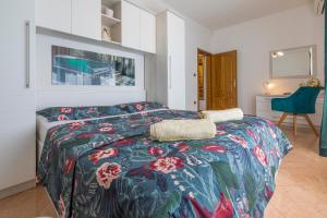 a bedroom with a bed with a colorful bedspread at Villa M in Crikvenica