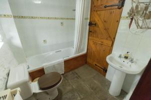 a bathroom with a toilet and a sink and a tub at The Granary in Bridgend +48 photos