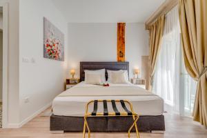 a bedroom with a large bed and a chair at Princ Heritage Rooms in Split