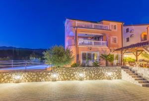 a large house with a stone wall at Villa M in Crikvenica