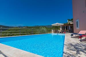 a swimming pool with blue water in a house at Villa M in Crikvenica