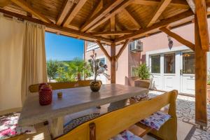 a dining room with a table and a large window at Villa M in Crikvenica