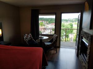 a hotel room with a table and chairs and a balcony at Riverside Tower in Pigeon Forge