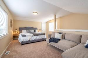 a bedroom with a bed and a couch at Modern home, Four bedrooms, King Beds in Tigard