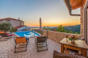 a patio with a table and chairs and a pool at Villa M in Crikvenica