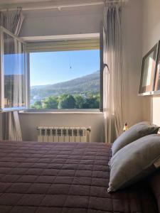 a bedroom with a large window and a bed with pillows at Barranca de San Miguel in Barreiros