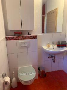a bathroom with a toilet and a sink at Schöne Wohnung in Röfingen in Röfingen