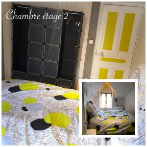 1 dormitorio con 1 cama y puerta de garaje amarilla en la petite forge, en Saint-Saturnin