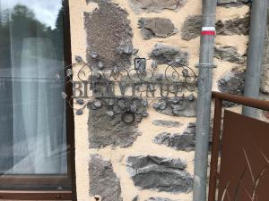 a wall with a decoration on the side of a building at la petite forge in Saint-Saturnin