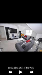 a living room with a couch and a living dining room and view at Paul’s Place, 5 minutes from the beach in Bournemouth