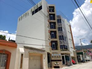 a tall white building on the corner of a street at Hotel Edén in Santiago Juxtlahuaca