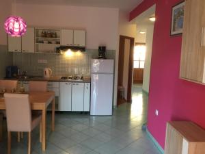 a kitchen with a white refrigerator and a table at Belic Vinko- house in Jelsa