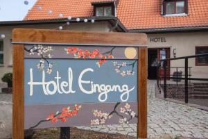 a sign in front of a hotel entrance at Landhotel Diana in Teltow