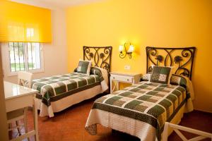 Posteľ alebo postele v izbe v ubytovaní Hostal Los Pinos