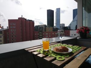 a table with a plate of food and a glass of orange juice at City center Raua apartment with balcony in Tallinn