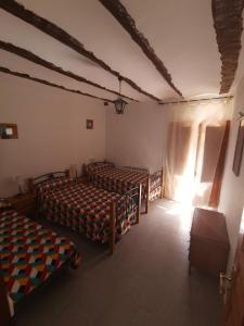 A bed or beds in a room at Casa Rural y Albergue Tormon