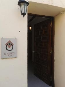 una entrada a un edificio con un cartel en una puerta en Casa Rural y Albergue Tormon en Tormón