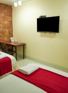 Voodi või voodid majutusasutuse Hotel Murali - Cerca del Aeropuerto de Guayaquil toas
